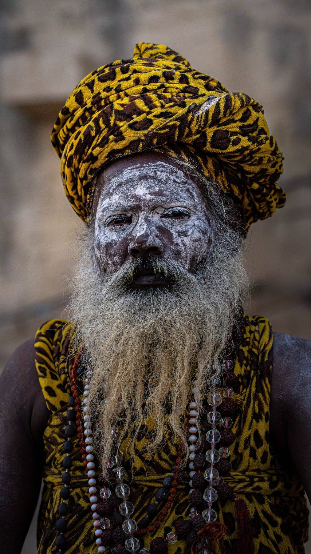 Sadhu mit aschebemaltem Gesicht und Leoparden-Turban, Indien